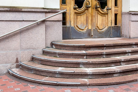 granite staircase with a rise to the wooden entrance door, threshold with steps to front door with...