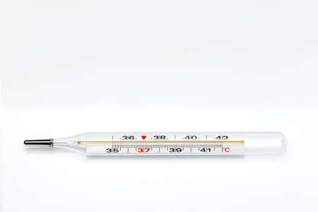 glass thermometer for measuring temperature and diagnosing health care, medical device isolated on a white background with copy space.の写真素材