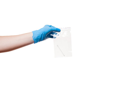 a hand in a blue sterile glove holds an airtight bag with a cotton swab for sampling smear analysis,...