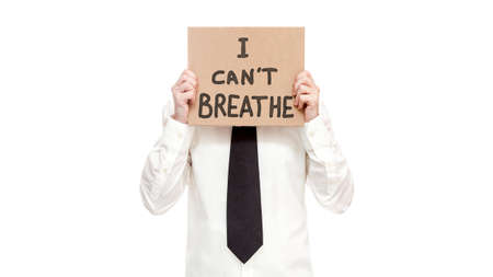 blm protest man in shirt with tie hold in hand a cardboard poster with the message text I can't breathe isolated on white backgroundの写真素材