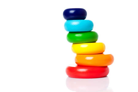 A big pyramid build from colored wooden rings of color lgbt flag isolated on a white background copy space.の写真素材