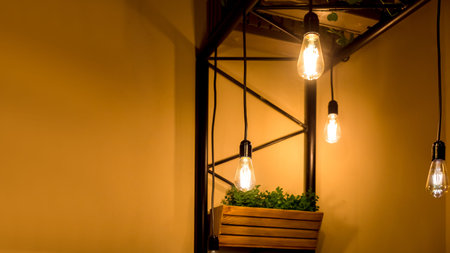 pendant edison bulbs in a cafe with wooden pots with green plants, vegetarian eco friendly interior...