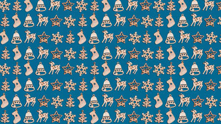 Christmas card pattern of wooden decorative figures on theme of New Year celebrations isolated on a blue background top view, ornamental objects lined up with recurring themes.の写真素材