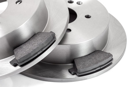 set of brake pad and brake disc new car spare parts brakes for a vehicle close up isolated on a white background close up view, nobody.の写真素材