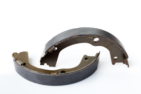 kit of drum brake pads with asbestos alloy on steel car spare parts, view hand brakes isolated on white background.の写真素材