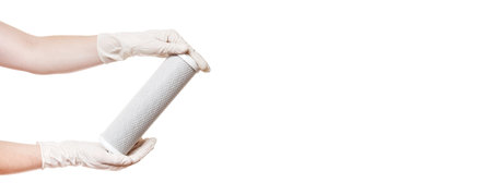 cartridge filter for drinking water purification carbon mesh demonstrate holding in hands in sterile gloves isolated on a white background banner with a copy space, faceless.の写真素材