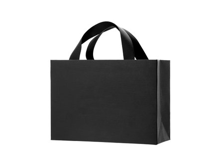 black paper bag from designer paper with ribbon handles, cardboard gift label bag mock up branding festive object isolated on white background, nobody.の写真素材