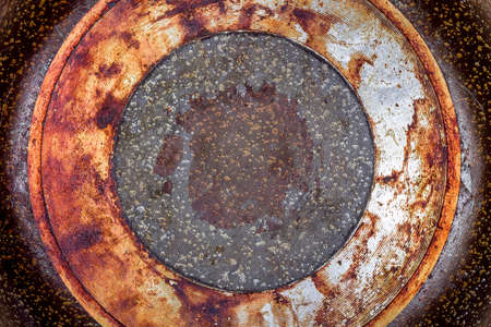 frying pan bottom view of the burnt greasy surface of the coating of utensils for cooking on a fire close-up.の写真素材