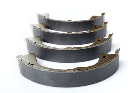 four brake shoes for drum brakes, spare parts for car consumables for service and maintenance of auto transport close up isolated objects on a white background asbestos alloy view, nobody.の写真素材
