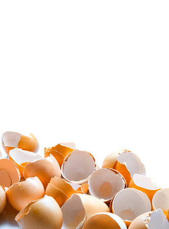 a pile of broken brown egg shells empty without protein content garbage after cooking, vertical...