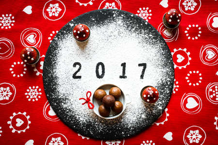 2017 Happy new year table with sugar and chocolate and christmas decorationsの写真素材