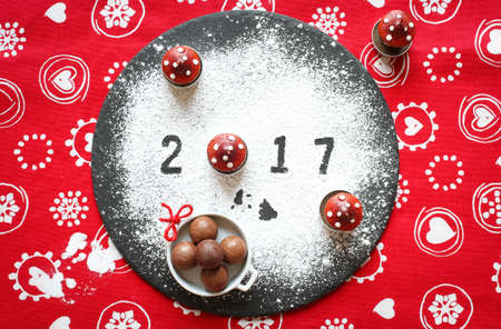 2017 Happy new year table with sugar and chocolate and christmas decorationsの写真素材