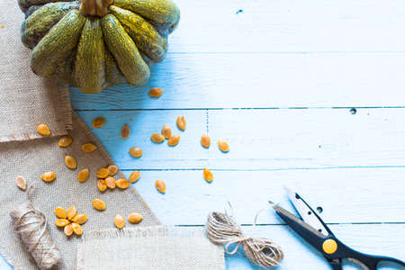Pumpkins on a wooden background with yuta, scissors, knifeの写真素材