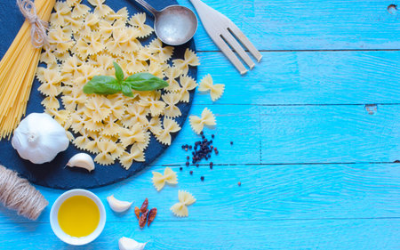 Italian pasta with pesto sauce made with basil leafs, pine nuts, fresh garlic and olive oil over an...