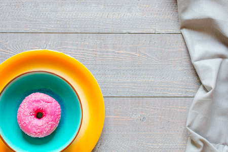 Morning breakfast with colorful Donuts on a rustic wooden background. Top viewの写真素材