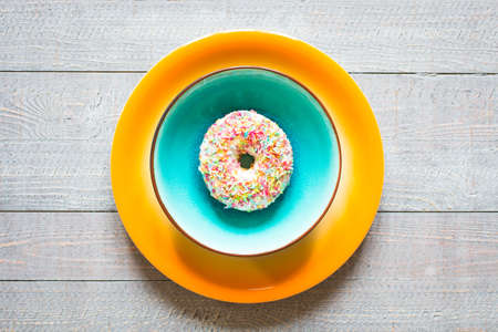 Morning breakfast with colorful Donuts on a rustic wooden background. Top viewの写真素材