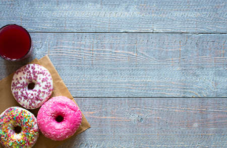Morning breakfast with colorful Donuts on a rustic wooden background. Top viewの写真素材