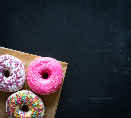 Morning breakfast with colorful Donuts on a rustic wooden background. Top viewの写真素材