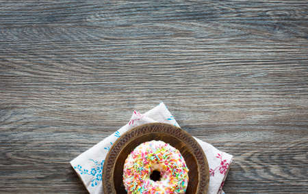 Morning breakfast with colorful Donuts on a rustic wooden background. Top viewの写真素材