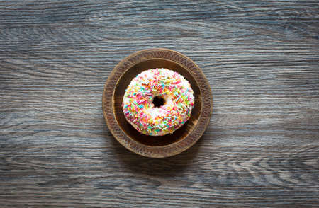 Morning breakfast with colorful Donuts on a rustic wooden background. Top viewの写真素材