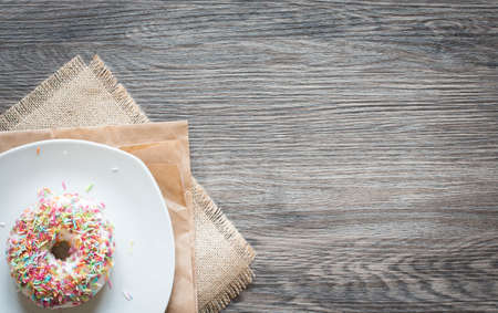 Morning breakfast with colorful Donuts on a rustic wooden background. Top viewの写真素材