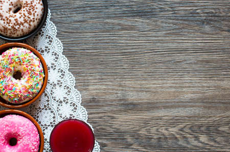 Morning breakfast with colorful Donuts on a rustic wooden background. Top viewの写真素材
