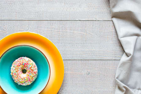 Morning breakfast with colorful Donuts on a rustic wooden background. Top viewの写真素材
