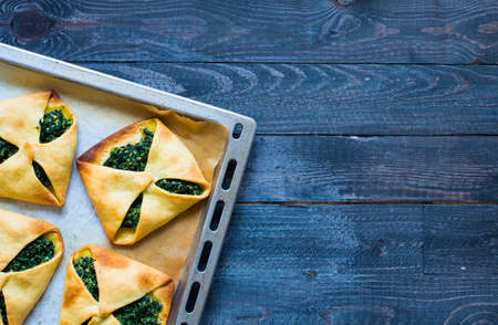 Spinach pie with ricotta cheese, on a wooden background.の写真素材