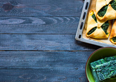 Spinach pie with ricotta cheese, on a wooden background.の写真素材