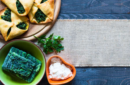 Spinach pie with ricotta cheese, on a wooden background.の写真素材