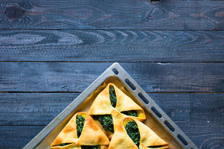 Spinach pie with ricotta cheese, on a wooden background.の写真素材