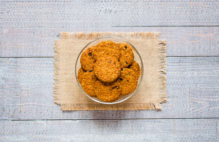 Healthy morning breakfast with cereal biscuits, over a wooden table background.の写真素材