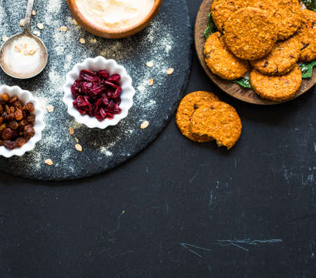 Healthy morning breakfast with cereal biscuits, dried cranberries and grapes, over a wooden table background.の写真素材