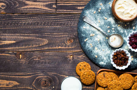 Healthy morning breakfast with cereal biscuits, dried cranberries and grapes, over a wooden table background.の写真素材