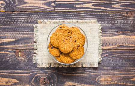 Healthy morning breakfast with cereal biscuits, over a wooden table background.の写真素材