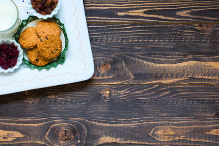 Healthy morning breakfast with cereal biscuits, dried cranberries and grapes, over a wooden table background.の写真素材