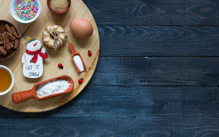 Christmas hand baked biscuits background with a lot of seasonal objects on a wooden old table.の写真素材