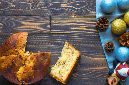 Panettone with chocolate and Christmas decoration on a wooden backgroundの写真素材