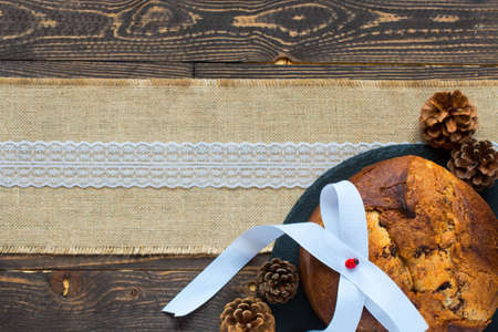 Panettone with chocolate and Christmas decoration on a wooden backgroundの写真素材