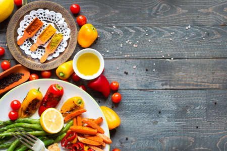 Grilled chicken breast with fresh vegetables on wooden backgroundの写真素材