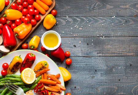 Grilled chicken breast with fresh vegetables on wooden backgroundの写真素材