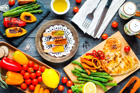 Grilled chicken breast with fresh vegetables on wooden backgroundの写真素材