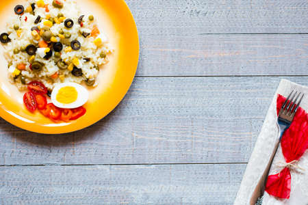 Vegetarian fresh salad with white rice and fresh colourful vegetables on wooden backgroundの写真素材