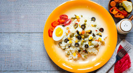 Vegetarian fresh salad with white rice and fresh colourful vegetables on wooden backgroundの写真素材