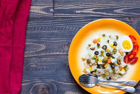 Vegetarian fresh salad with white rice and fresh colourful vegetables on wooden backgroundの写真素材