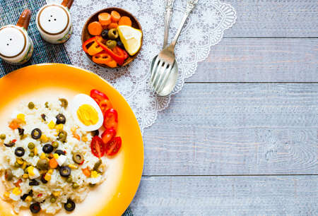 Vegetarian fresh salad with white rice and fresh colourful vegetables on wooden backgroundの写真素材