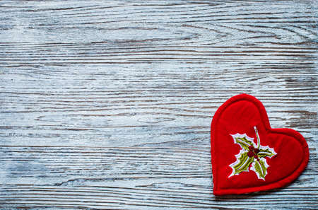 Red heart with candle copyspace for Valentines or Christmas on wooden backgroundの写真素材