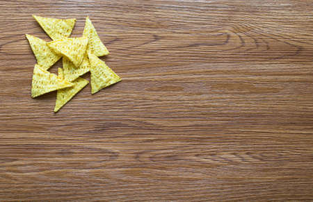 Mexican nachos chips with spicy tomato sauce on wooden backgroundの写真素材