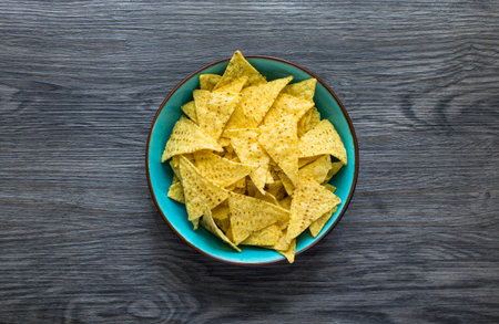 Mexican nachos chips with spicy tomato sauce on wooden backgroundの写真素材