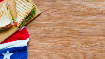Top view of Healthy Sandwich toast with lettuce, ham, cheese and tomato on a wooden backgroundの写真素材